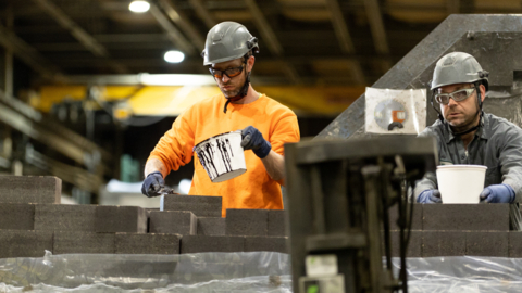 Two RHI Magnesita employees working (Photo: Business Wire)