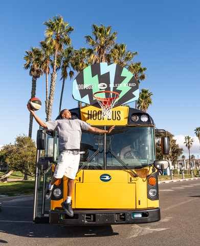 Blue Bird donated an all-electric school bus to Hoop Bus, a California-based nonprofit organization. Pictured here is professional basketball player and movie actor Elvin Rodriguez dunking on the first zero-emission hoopbus. (Image provided by Hoop Bus)