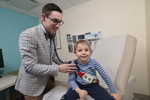 original Dr. Jake Kleinmahon examines a patient. Photo courtesy Northwell Health.