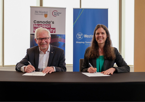 original Dr. John Preston of McMaster University and Westinghouse Vice President Leah Crider sign the MoU for collaboration on the eVinci technology.
