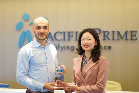 original Pierre Morin, Global Head of Sales at Pacific Prime (left) receiving the 2024-2025 Best Business Partner Award from Jane Li of Now Health International (right)