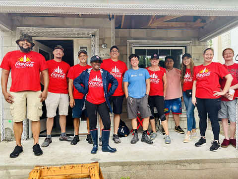 original Coke Florida associates volunteering with Habitat for Humanity to support the home building and landscaping efforts at the new home.