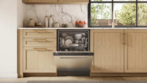 original The all-new Bosch 500 Series dishwasher is shown with a partially open door and features clean dishes on the upper rack.