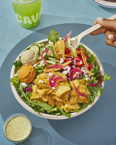 original Garlicky Chicken Shawarma Bowl: A street cart-inspired chicken + rice bowl, bursting with bold ingredients. Chicken shawarma is paired with red pepper hummus, Crazy Feta®, corn, tomato + cucumber, pickled onions, fiery broccoli, arugula, saffron basmati rice, and the one-two, flavor-packed punch of skhug + garlic dressing.