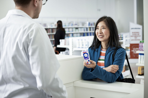 original A pharmacist advises a consumer on the purchase of Haleon’s Otrivin nasal mist.