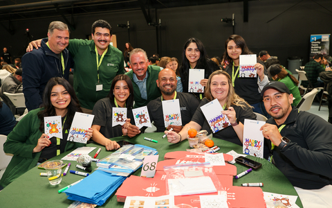 original Brett Martinez (center), President and CEO of Redwood Credit Union, poses with team members who decorated care bags and birthday boxes for foster youth in San Francisco and the North Bay counties RCU serves. The event is part of RCU’s biennial Day of Impact, when team members come together to create meaningful change that lasts well beyond a single day. (Will Bucquoy/Redwood Credit Union)