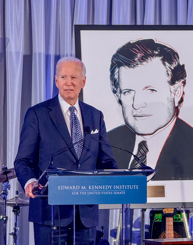 original Former President Biden speaks Sunday night, in front of an illustration of late Senator Edward Kennedy, at the Edward M. Kennedy Institute for the United States Senate in Boston. In a dinner marking its 10th anniversary, the institute awarded President Biden its Lifetime Achievement Award.