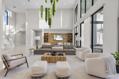 thumbnail Expansive rooms with soaring ceilings create a luminous, airy ambiance, accented by a striking moss chandelier. (Photo Credit: Justin Lawrence)