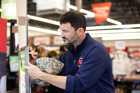 Hal Lawton, President and CEO of Tractor Supply, signs the honor wall at the Hometown Hero celebration at the Woodbridge, Virginia, Tractor Supply Store. Today, every Tractor Supply Store nationwide held a celebration in honor of National Hometown Heroes Day, and the company donated more than $1 million to military, veteran and first responder organizations.