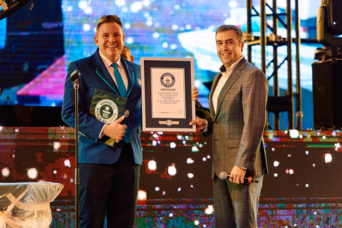 thumbnail Rodolfo Ramirez, PPG vice president, Automotive Refinish Coatings, Americas, seen holding the certificate for breaking the world record attempt with Michael Empric, GUINNESS WORLD RECORDS™ adjudicator.