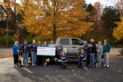 original James West, Chief Actuary, Fortitude Re and Cumberland River Compact (CRC) Board Member is joined by Fortitude Re volunteers during the check presentation to CRC Executive Director Mekayle Houghton.