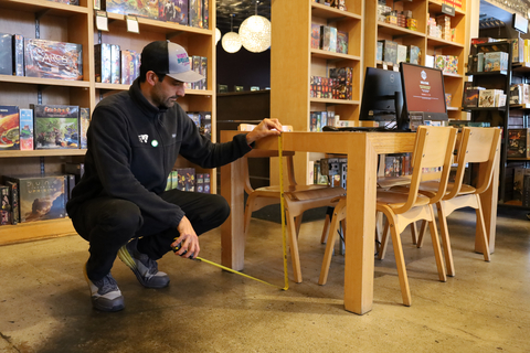 thumbnail Wheel the World mapper measures table height as part of the process of verifying 25 local businesses in Bellevue, Washington.