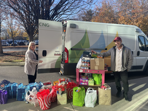 Avangrid employees stand with food drive donations