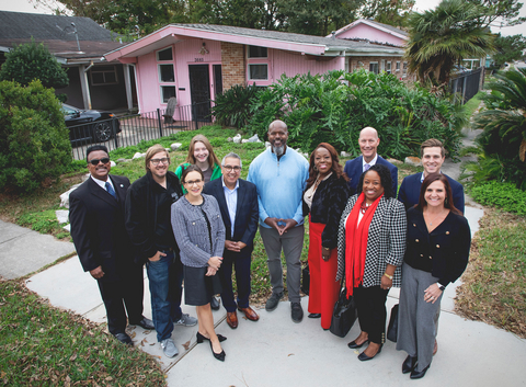 Ivan Watkins (center, light blue) received a $15,000 DRA grant from FHLB Dallas through Hancock Whitney Bank to upgrade to a FORTIFIED roof that can better withstand storms.