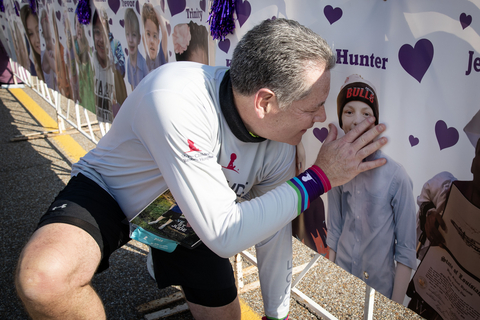 thumbnail John, the father of a St. Jude patient, pauses with a photo of his son, Hunter. He carries Hunter’s memory with him each St. Jude Memphis Marathon Weekend and is an active fundraiser through the St. Jude Heroes program.