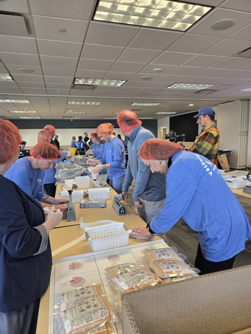 original Volunteers from Peoples Natural Gas pack meals to support nonprofit Rise Against Hunger through Essential's annual Fall for Food Banks initiative.