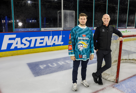 Fastenal and the Belfast Giants recently entered into a sponsorship agreement. Gabe Bast, Defenseman for the Belfast Giants and Steve Thornton, Sports Director for The Odyssey Trust, pose in front of Fastenal's rink board at The SSE Arena, Belfast.