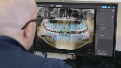 original A dentist reviews a panoramic radiograph with support from Pearl’s Second Opinion® AI, now FDA-cleared for automated detection of dental pathologies on panoramic x-rays.