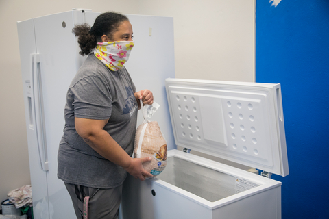 thumbnail GE Appliances employees placing donated frozen food into a community freezer to support local families. (Photo: GE Appliances, a Haier company)