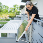 Plug_in_solar_image_with_woman_installing_a_solar_panel_on_her_balcony.jpg