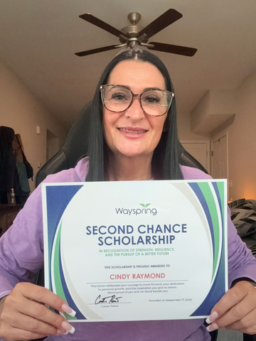 Cindy Raymond receives her Second Chance Scholarship, which will support her efforts to clear a decades‑old criminal record.