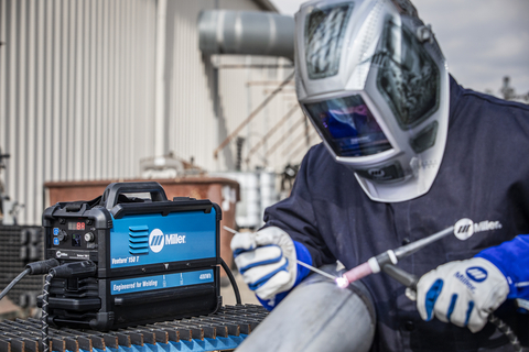 Battery powered welder next to someone TIG welding.