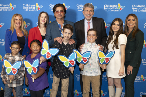 Back: Jillian Green, Associate Vice President of Corporate Partnerships; Alexandra Carter, Senior Vice President and Chief Development Officer; John Stamos, actor, musician, and CHLA supporter; Paul S. Viviano, President and Chief Executive Officer; CHLA patient Sasha; Dawn Wilcox, Vice President of Development and Corporate Partnerships. Front: CHLA patients Nano, Julie Rose, Elliott, and Pierce.