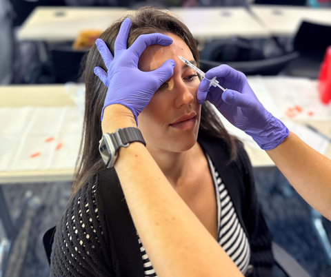 original A MySpaLive student performs a supervised neurotoxin injection on a live model during hands-on clinical training, emphasizing safety, technique, and real-world experience.