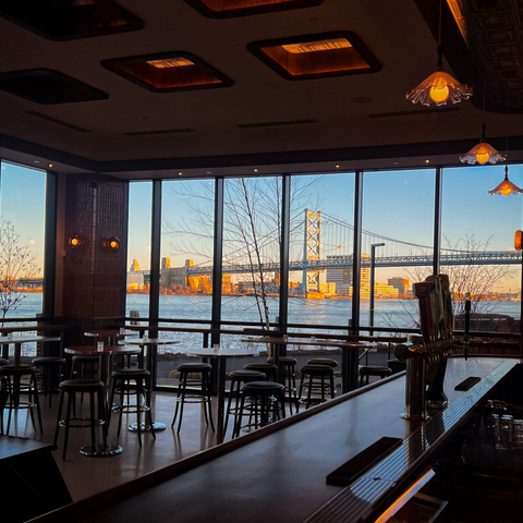 Patrons of the new Lucky Duck tavern at Rivermark Northern Liberties, a mixed-use community on the Philadelphia waterfront, will enjoy stunning views of the Delaware River and the Ben Franklin Bridge. Credit: Neal Santos