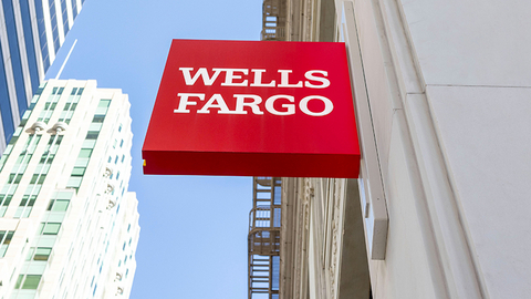 Wells Fargo red sign displayed on a city building exterior.
