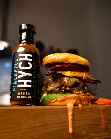 original HYCH hot sauces—one of many Oregon brands supported through Market of Choice’s MOJO program —adds bold, local flavor to this Pineapple Bacon Burger. Photo credit: Alyna Desmond
