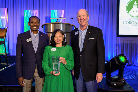 Tiko Russell, center, winner of Regions Bank’s Lee Ann Petty Heart of Service Award. The award was presented by Regions Chairman, President and CEO John Turner, right, and Leroy Abrahams, head of Community and Market Engagement, left.