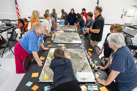 original Community members review neighborhood maps and provide feedback during a Port Houston listening session, helping guide the Anchored in Action Community-Investment Plan.