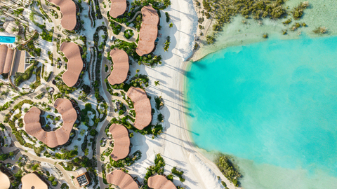 An aerial view of Four Seasons Resort and Residences at Shura Island, set along the shoreline with clear views of the Red Sea.
