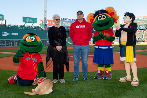 original Former Army officer and VEG ER for Pets Veterinary Assistant Max Bassett joins service dog of the game Cali, her mom, and the Boston Red Sox mascots on the field at Fenway Park before the May 12, 2026 game.