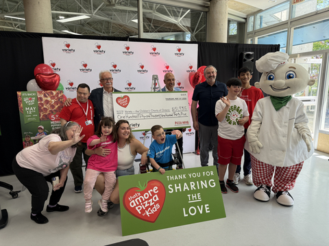 original Domenic Primucci, president of Pizza Nova, presents a cheque for $151,935 to Charlie Johnstone, President & CEO of Variety – the Children’s Charity of Ontario, at Variety Village, on May 19, 2026. The donation was made following Pizza Nova’s 2026 That’s Amore Pizza for Kids fundraiser. Joining the presentation were Pizza Nova founder Sam Primucci, Variety ambassadors, family members and Pizza Nova mascot Leonardough. Pictured left to right: Matthew Hoffman, Variety Ambassador, Sam Primucci, CEO and Founder of Pizza Nova, Domenic Primucci, President of Pizza Nova, Charlie Johnstone, President & CEO Variety – the Children’s Charity of Ontario, Georgio Gonsalves, Variety Ambassador, Tyler Jahoor, Variety Ambassador, Leonardough, Dyanna McIlwain, Ranee-Jessie grandmother, Ranee-Jessie Maxwell, Variety Ambassador, Effie Tanos, Petros’ mom, Petros Tanos, Variety Ambassador.