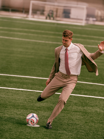 Built to move. Walker Zimmerman shows off high-performance tailoring in the Slim Tan Washable Chino Blazer, Slim Comfort Waist Hyper Stretch Chino and a Striped Long Sleeve Poplin Shirt.