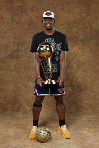 original OG Anunoby hoists the 2026 NBA Championship trophy in SKX Nexus basketball shoes – the first NBA champion to win it in Skechers.