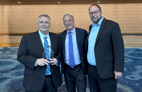 Everforth ECSers Deron Baker (left) and Vic Bogar (right) pose with David Steiner, USPS Postmaster General (center), with award.