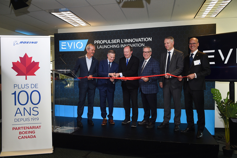original EVIO cuts the ribbon on its office in Dorval, Québec. From left to right: Colonel Chris Hadfield, Michael Derman, Chief Executive Officer, EVIO, Luc Van Bavel, Chief Technology Officer, EVIO, Yves Beauchamp, President and Chief Executive Officer, Aéroports de Montréal, Al Meinzinger, President, Boeing Canada, and Marc Doret, Mayor of the City of Dorval.