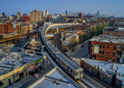 original A CTA Brown line train traveling on the new Red-Purple Bypass at the Belmont Station crossing. The elevated bypass eliminates track conflicts and improves throughput for Red, Purple and Brown Line service. Note the Chicago skyline in the background.
