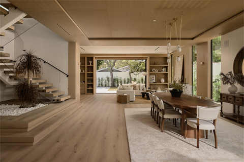 original Framed by floor-to-ceiling windows and disappearing pocket glass doors, the living room is a masterclass in soft contemporary design, seamlessly extending to the resort-style backyard. Warm hardwood floors, soaring volume ceilings and a dramatic fireplace wrapped in striking Patagonia stone create an inviting yet sophisticated atmosphere. Natural light fills the space, highlighting bespoke finishes and the home's effortless indoor-outdoor connection. Thoughtfully designed by award-winning team Yuna Megre and Maria Mikena, this elegant gathering space balances modern architecture with organic textures, delivering a timeless setting for everyday living, entertaining and enjoying the California lifestyle at its finest. Photo Credit: Will Myers