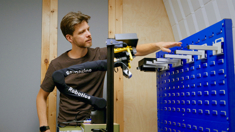 original Reimagine Robotics CEO Jonathan Scholz with the company's AI-powered robot learning on the job. Credit: Reimagine Robotics
