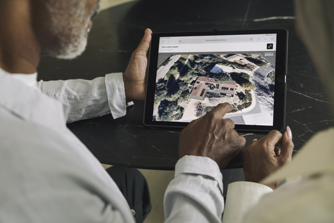 Two people using the Aurora Solar Marketplace on a tablet device.