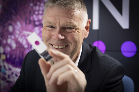 original Professor David Brettle, Chief Scientific Officer at Leeds Teaching Hospitals NHS Trust with a pathology slide showing the TANGO technology.