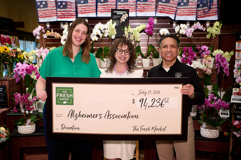 original John Koulouris, vice president of operations (R) and Meredith Barnes, marketing manager (L) both of The Fresh Market present a ceremonial check to Christine John-Fuller, Executive Director, Alzheimer’s Association North Carolina, (C) for The Fresh Market’s June Alzheimer’s and Brain Awareness Month fundraising campaign. (Photo: The Fresh Market)