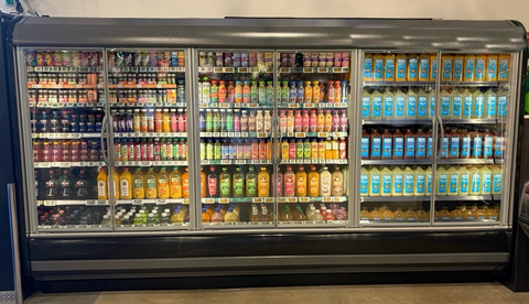 original A recent Buda Fresh installation at a large grocery retailer. The Buda Fresh section (right) represents roughly 1/3 of the cooler, which the Company believes outsells the remaining 2/3 that hold conventional pasteurized juices.