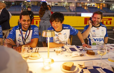 thumbnail Yuki Tsunoda at La Tavolata by Barilla alongside members of the Visa Cash App Racing Bulls team.