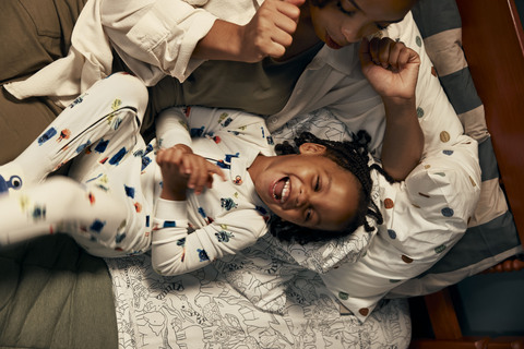 A child laughs wearing the DreamPlush Footed Pajama from Carter's latest Not-So-Scary Monsters collection.