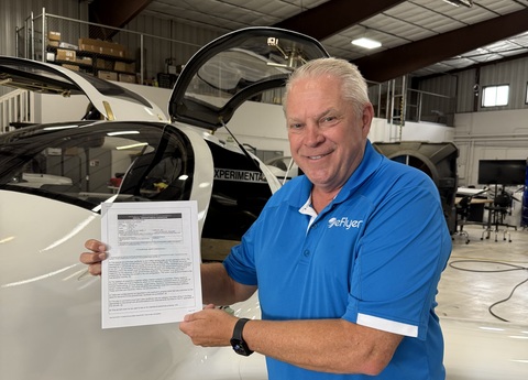 original Rod Zastrow, Bye Aerospace CEO, holds the newly awarded FAA Special Airworthiness Certificate for eFlyer 2, Serial No 001.